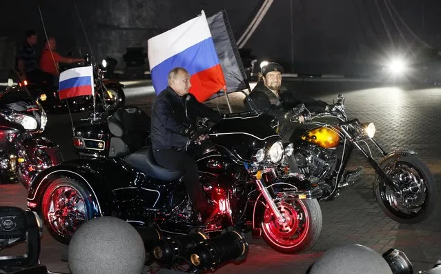 In this file photo taken on Monday, August 29, 2011, then Russian Prime Minister Vladimir Putin rides three wheeler at centre, accompanied by the Night Wolves biker group leader Alexander Zaldostanov, right, at Novorossiysk, Russia. Poland's Prime Minister Ewa Kopacz spoke out Wednesday April 15, 2015, against plans by Russian nationalistic Night Wolves biker group to ride through Poland on a journey to Berlin to mark the 70th anniversary of the Soviet victory over Nazi Germany. (Photo by Ivan Sekretarev/AP Photo)