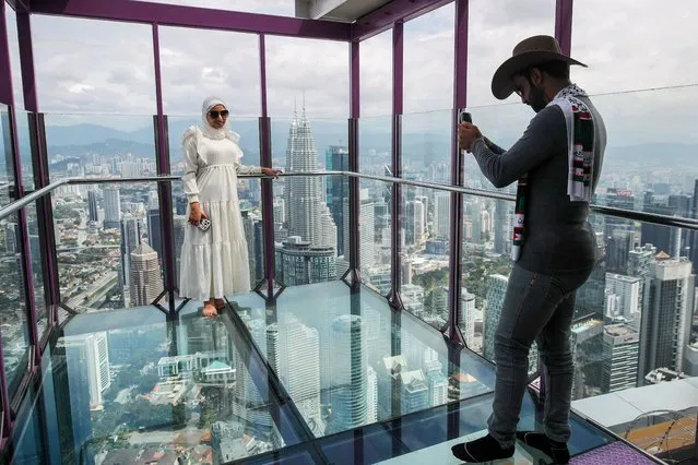 Visitors take pictures inside Kuala Lumpur Tower's “Sky Box”, one of the city's touristic attractions, in Kuala Lumpur, Malaysia, 05 January 2024. Malaysian Tourism Minister Tiong King Sing recently said that the tourism industry “is not just an engine for economic growth but also a bridge for cultural exchange and international friendship”. (Photo by Fazry Ismail/EPA/EFE)