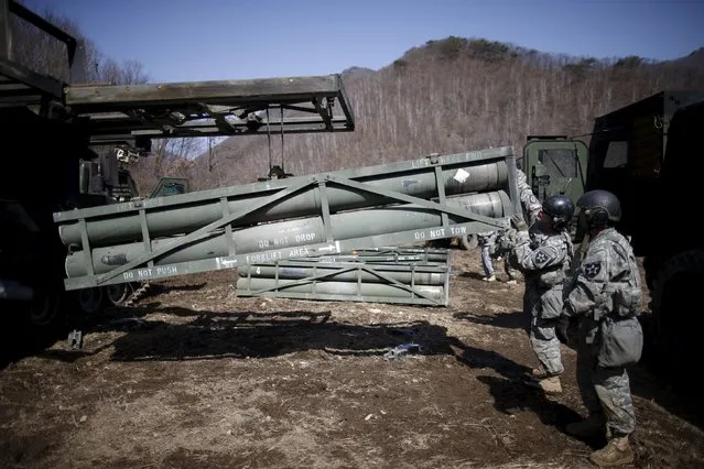A U.S. army soldier loads rocket pods on a M270A1 multiple launch rocket system as they prepare for a live-fire training exercise of the 6-37th Field Artillery Regiment at a training area near the demilitarized zone separating the two Koreas, in Cheorwon, South Korea, March 9, 2016. (Photo by Kim Hong-Ji/Reuters)