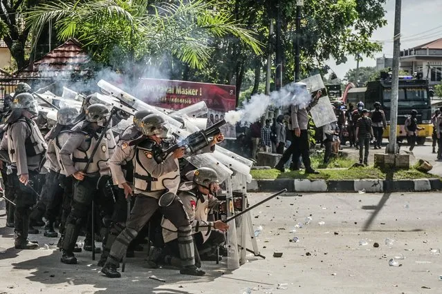 Police officers fired tear gas at protesters who started throwing stones in Kendari, Indonesia on September 27, 2021. The Halu Oleo Kendari University Student Union, Southeast Sulawesi, held a demonstration demanding a thorough investigation into the shooting that killed two students by police officers at the Southeast Sulawesi Regional Police Headquarters on Monday. This action marks the 2nd anniversary of the deaths of Immawan Randi and La. Ode Yusuf Wijaya who was shot dead on Thursday, September 26, 2019. (Photo by Andry Denisah/ZUMA Press Wire/Rex Features/Shutterstock)