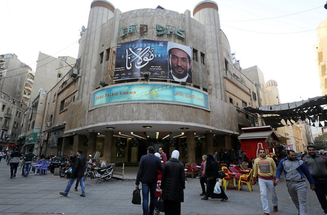 Egyptians walk past an advertisement featuring the Egyptian film “Mawlana” (The Preacher) at a cinema in Cairo, Egypt January 23, 2017. (Photo by Mohamed Abd El Ghany/Reuters)