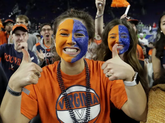 Virginia fans cheer before a semifinal round game against Auburn at the Final Four NCAA college basketball tournament, Saturday, April 6, 2019, in Minneapolis. (Photo by David J. Phillip/AP Photo)