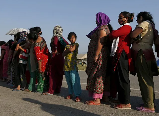 Women queue for food supplies at a camp for displaced earthquake victims in Kathmandu, Nepal, May 5, 2015. (Photo by Olivia Harris/Reuters)