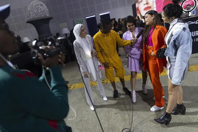 A journalist interviews guests during the African Fashion International (AFI) Cape Town Fashion Week, Cape Town, South Africa 13 April 2019. (Photo by Nic Bothma/EPA/EFE)