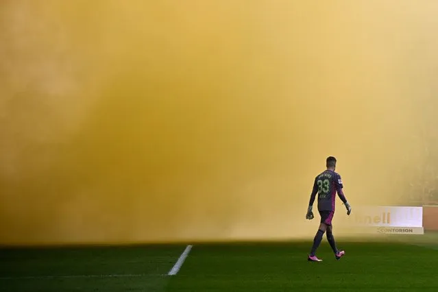 Dortmund's German goalkeeper #33 Alexander Meyer walks across the pitch as smoke from flares burnt by football fans obstructs the view at the start of the German first division Bundesliga football match 1. FC Union Berlin v BVB Borussia Dortmund in Berlin on March 2, 2024. (Photo by Tobias Schwarz/AFP Photo)