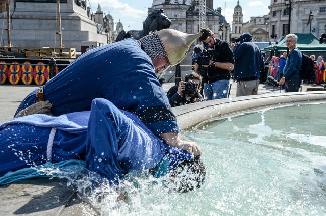 One of Jesus' disciples is dunked in a fountain during The Wintershall's “The Passion of Jesus” in front of crowds on Good Friday at Trafalgar Square on March 25, 2016 in London, England. (Photo by Chris Ratcliffe/Getty Images)