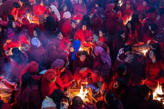 Nepalese Hindu women warm themselves by fires after taking a mass holy bath in the Salinadi River during the Madhav Narayan festival in Sankhu, on the outskirts of Kathmandu, Nepal, 01 February 2024. The Madhav Narayan festival is a full month-long event devoted to religious fasting, holy bathing and the study of the Swasthani book, which is dedicated to the God Shiva and Goddess Swastania. A chapter of the story is read each evening by priests or householders to the gathered family. Hundreds of married women and dozens of male devotees complete a month-long fast for a better life and peace in the country at various temples; unmarried women take the fast to attract a suitable husband and married women take the fast in hopes of improving their families' prosperity. (Photo by Narendra Shrestha/EPA/EFE)