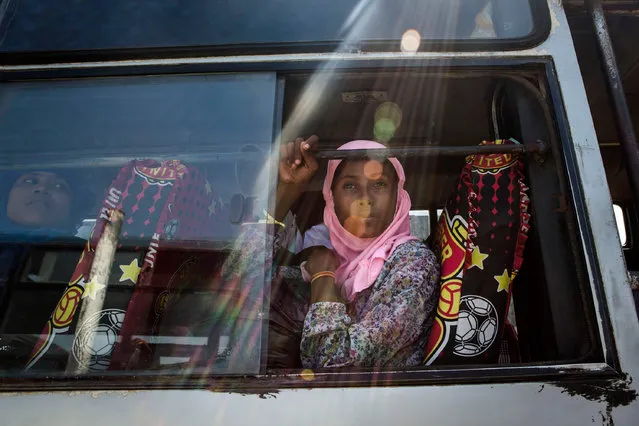 A Rohingya girl sits on a bus as relocated to their new temporary shelter on May 13, 2015 in Lhoksukon, Aceh province, Indonesia. Boats carrying over 500 of Myanmar's Rohingya refugees have arrived in Indonesia, many requiring medical attention. They have warned that thousands more are thought to be still at sea. (Photo by Ulet Ifansasti/Getty Images)