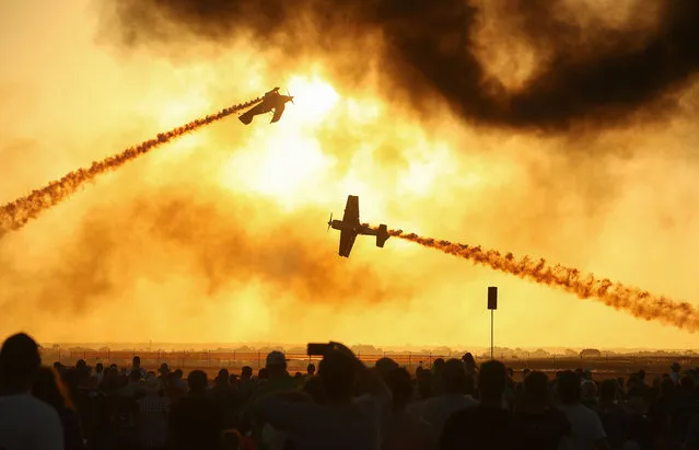 A crowd of spectaors watch as the Oris TinStix of Dynamite aerobatic team featuring American Skip Stewart and Triple world aerobatics champion Jurgus Kairys perform at The Australian International Airshow on March 3, 2017 in Avalon, Australia. (Photo by Scott Barbour/Getty Images)