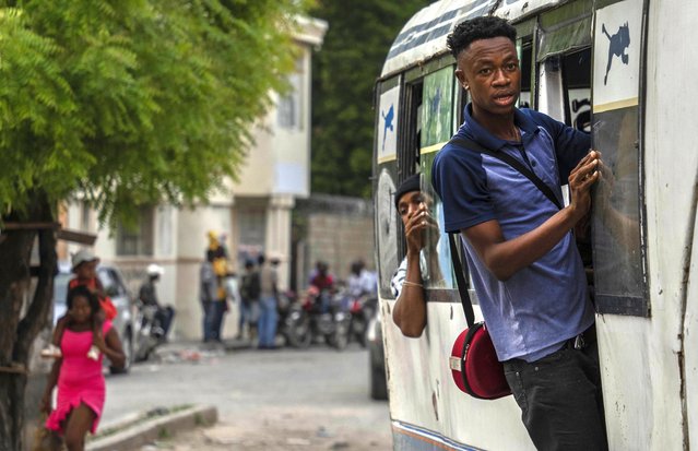 Passengers ride on a bus in downtown Port-au-Prince, Haiti, Friday, April 26, 2024. (Photo by Ramon Espinosa/AP Photo)