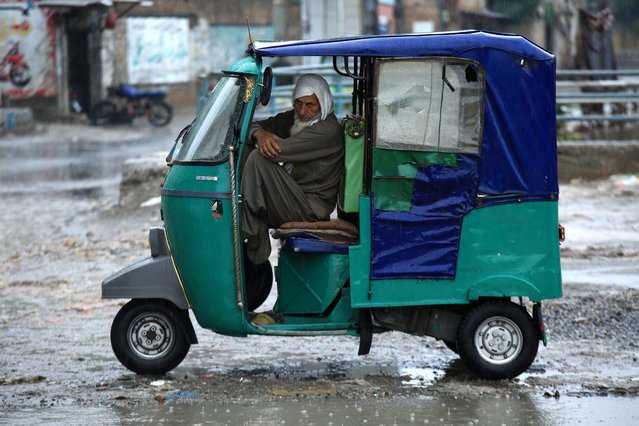 A man looks on from inside of his vehicle during heavy rain in Peshawar, Pakistan, 15 April 2024. According to the Khyber Pakhtunkhwa (KP) provincial disaster management authority, at least 29 people have died and another seven have been injured in the last three days due to lightning strikes and incidents related to the torrential rains affecting several provinces. (Photo by Arshad Arbab/EPA/EFE)