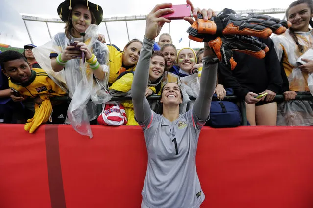 Australia goalkeeper Lydia Williams (1) takes a selfie with fans after the game against Sweden in Edmonton, June 16, 2015. (Photo by Erich Schlegel/USA TODAY Sports)