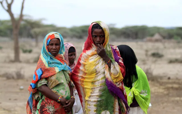 Women wait to receive supplementary food at a distribution centre in Gelcha village, one of the drought stricken areas of Oromia region, in Ethiopia, April 28, 2016. (Photo by Tiksa Negeri/Reuters)