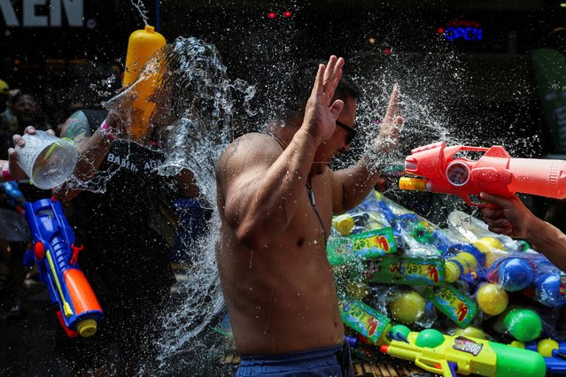 A man is splashed with water as he celebrates the Songkran holiday which marks the Thai New Year in Bangkok, Thailand, on April 13, 2024. (Photo by Chalinee Thirasupa/Reuters)