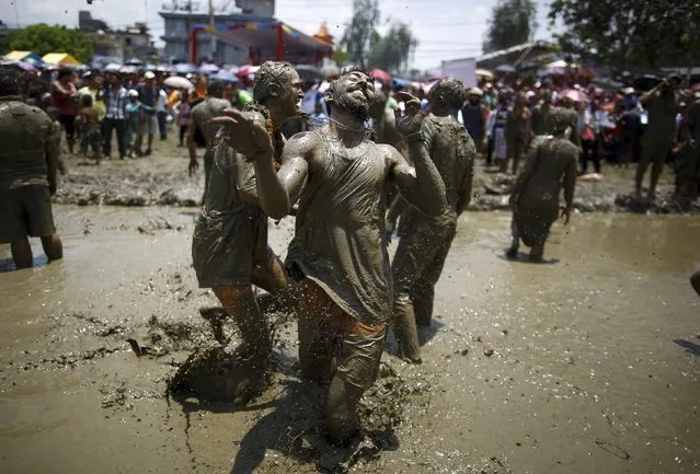 A tourist tries to dodge mud during the Asar Pandhra festival in Pokhara valley, west of Nepal's capital Kathmandu, June 30, 2015. (Photo by Navesh Chitrakar/Reuters)