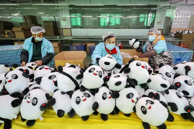 Workers produce Bing Dwen Dwen plush toys at the workshop of Jinjiang Hengsheng Toys Co., Ltd. on February 8, 2022 in Jinjiang, Fujiang Province of China. (Photo by VCG/VCG via Getty Images)