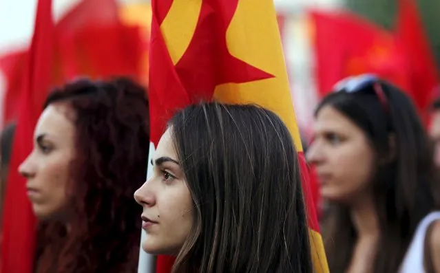 Supporters of the Greek Communist Party listen to a speech during a rally on Constitution (Syntagma) square, near the parliament building, in Athens, Greece, July 2, 2015. The International Monetary Fund delivered a stark warning on Thursday of the huge financial hole facing Greece as angry and uncertain voters prepare for a referendum that could decide their country's future in Europe. (Photo by Jean-Paul Pelissier/Reuters)