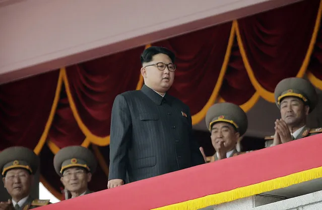 North Korean leader Kim Jong Un, center, watches parade participants from a balcony at the Kim Il Sung Square on Tuesday, May 10, 2016, in Pyongyang, North Korea. Hundreds of thousands of North Koreans celebrated the country's newly completed ruling-party congress with a massive civilian parade featuring floats bearing patriotic slogans and marchers with flags and pompoms. (Photo by Wong Maye-E/AP Photo)