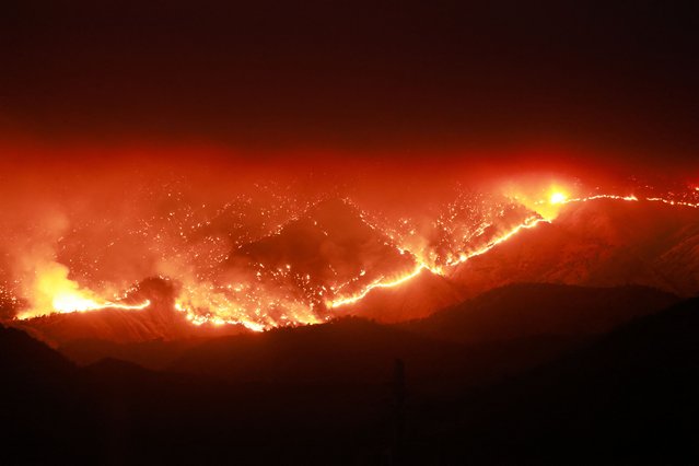 Embers glow at night as the Basin Fire burns in the Sierra National Forest in Fresno County, California, on June 26, 2024. A trio of wildfires, named the “June Lightning Complex Fire”, in the county have burned 7,002 acres (2834 hectares), and together are 15 percent contained, with evacuation orders in place by Cal Fire authorities. (Photo by David Swanson/AFP Photo)