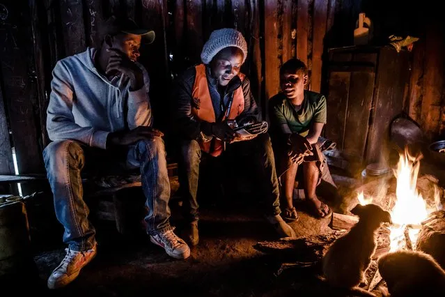 Enumerator Janet Ngusilo, center, records details of an Ogiek family participating in the census inside a home in Mau Forest of Narok County, Kenya on August 28, 2019. (Photo by Luis Tato/The Washington Post)