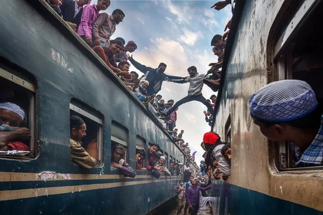 Time To Go Home. David Nam Lip Lee describes his photo: “Youngsters having fun on the roof of the train. There are too many people who rushing home after the Bishwa Ijtema at Tongi train station of Bangladesh”. (Photo by David Nam Lip Lee/National Geographic Travel Photographer of the Year Contest)