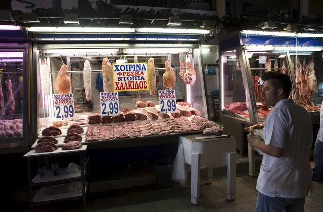 A butcher stands in front of his shop inside Athens' main meat market July 25, 2015. (Photo by Ronen Zvulun/Reuters)