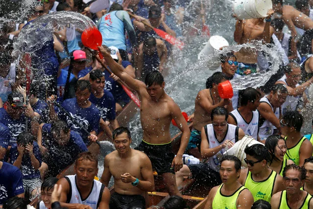 Participants splash water during a ceremony in between races during Tung Ng or Dragon Boat Festival at Aberdeen fishing port in Hong Kong June 9, 2016. (Photo by Bobby Yip/Reuters)