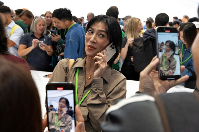 An attendee makes a video with the new iPhone 16 Pro as Apple holds an event at the Steve Jobs Theater on its campus in Cupertino, California on September 9, 2024. (Photo by Manuel Orbegozo/Reuters)