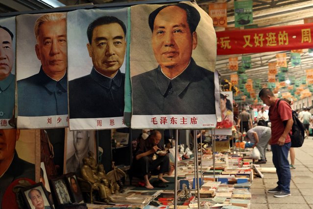 Posters depicting late Chinese chairman Mao Zedong and other former Chinese leaders are displayed for sale at the secondhand books section of Panjiayuan antique market in Beijing, China on August 3, 2024. (Photo by Florence Lo/Reuters)