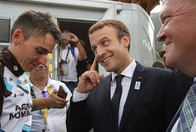 French President Emmanuel Macron, center, talks to France's Romain Bardet as Danish Prime Minister Lars Lokke Rasmussen, right, looks on, after the seventeenth stage of the Tour de France cycling race over 183 kilometers (113.7 miles) with start in La Mure and finish in Serre-Chevalier, French Alps, Wednesday, July 19, 2017. (Photo by Christophe Ena/AP Photo)