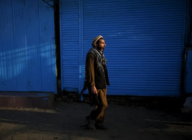 An Afghan man yawns as he walks at a market in the early morning hours in Kabul, Afghanistan July 30, 2015. (Photo by Ahmad Masood/Reuters)