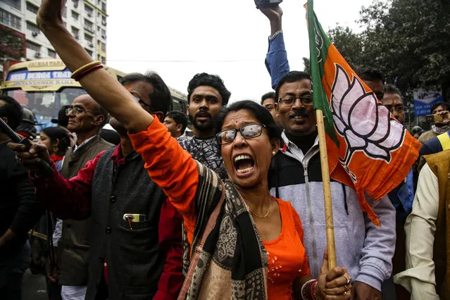 Supporters and leaders of India's ruling Bharatiya Janata Party (BJP) shout slogans during a rally supporting a new citizenship law that opponents say threatens India's secular identity, in Kolkata, India, Friday, February 7, 2020. The law provides a fast-track to naturalization for persecuted religious minorities from some neighboring Islamic countries, but excludes Muslims. (Photo by Bikas Das/AP Photo)