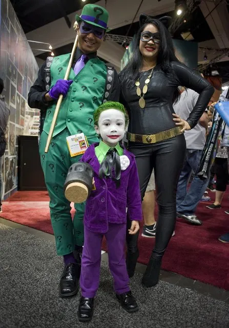 Clark Del Rosario (5) from San Diego dressed as the Batman villain character, The Joker, attends the preview evening event at Comic-Con 2014 in San Diego, California. Behind him are his parents, Lester and April Del Rosario. (Photo by David Maung/EPA)