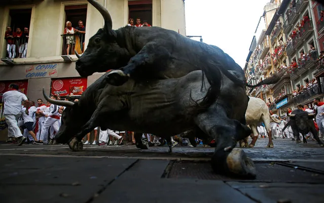Jose Escolar Gil fighting bulls fall on top of each other at Estafeta corner during the third running of the bulls at the San Fermin festival in Pamplona, northern Spain, July 9, 2016. (Photo by Eloy Alonso/Reuters)