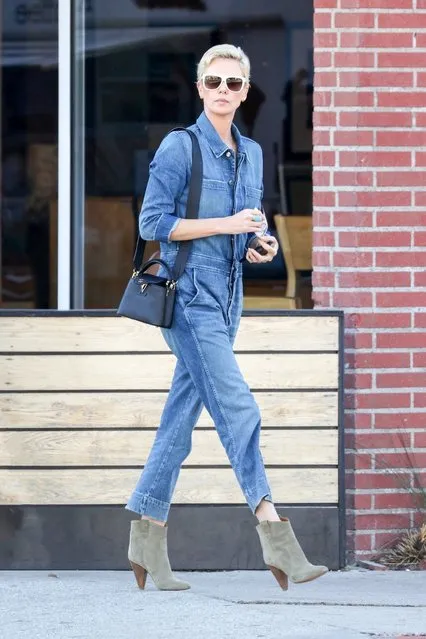 Charlize Theron rocks a denim jumpsuit for lunch at Sugarfish in Los Angeles, CA. on March 3, 2020. The actress pairs a pair of suede booties with her look and completes the ensemble with black shades. (Photo by Backgrid USA)