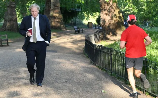 Prime Minister Boris Johnson takes a morning walk in St James's Park in London before returning to Downing Street on Wednesday May 6, 2020. (Photo by Stefan Rousseau/PA Images via Getty Images)