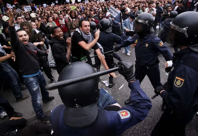 SEPTEMBER 25: Protesters clash with police during a march against austerity measures in Madrid. Spain's Parliament has taken on the appearance of a heavily guarded fortress with dozens of police blocking access from every possible angle, hours ahead of a protest against the conservative government's handling of the economic crisis. The demonstration, organized behind the slogan 'Occupy Congress,' is expected to draw thousands of people. (Andres Kudacki/Associated Press)