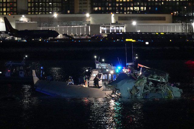 Emergency units respond after a passenger aircraft collided with a helicopter in the Potomac River near Ronald Reagan Washington Airport on January 30, 2025 in Arlington, Virginia. An American Airlines flight from Wichita, Kansas collided with an Army helicopter while approaching Ronald Reagan National Airport. (Photo by Andrew Harnik/Getty Images)