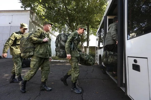 Russian recruits take a bus near a military recruitment center in Krasnodar, Russia, Sunday, September 25, 2022. Russian President Vladimir Putin on Wednesday ordered a partial mobilization of reservists to beef up his forces in Ukraine. (Photo by AP Photo/Stringer)