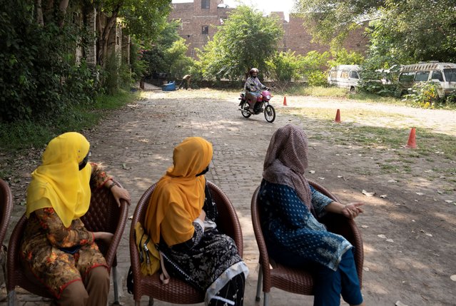 Ishrat Khan practices riding a motorbike as others watch her, during a training session as part of the “Women on Wheels” program organised by the traffic police department in Lahore, Pakistan, on October 1, 2024. (Photo by Nida Mehboob/Reuters)