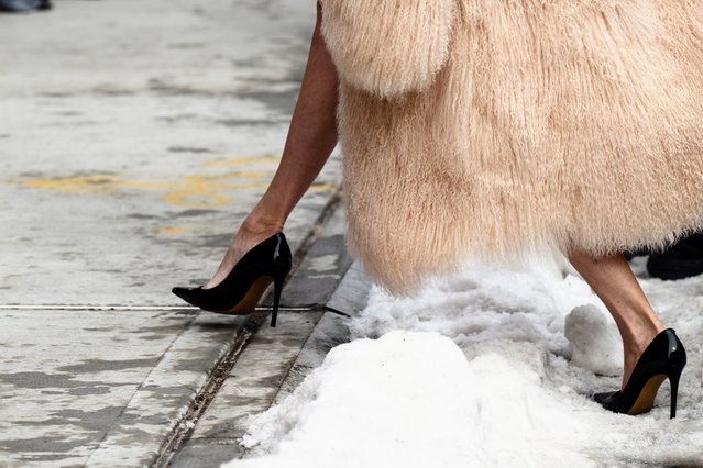 Who needs snow boots? One attendee took a quick hop over the snow in stilettos to get to the Michael Kors show on February 11, 2025 in New York City. (Photo by Marvin Joseph/The Washington Post)