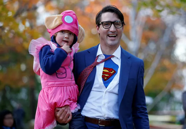 Canada's Prime Minister Justin Trudeau carries his son Hadrien while participating in Halloween festivities at Rideau Hall in Ottawa, Ontario, Canada, October 31, 2017. (Photo by Chris Wattie/Reuters)