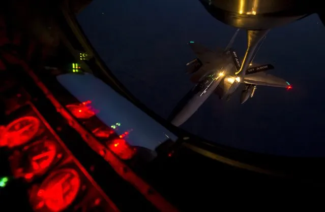 A U.S. Air Force F-15E Strike Eagle receives fuel from a KC-135 Stratotanker over northern Iraq after conducting airstrikes in Syria, in this U.S. Air Force handout photo taken September 23, 2014. These aircraft were part of a large coalition strike package that was the first to strike ISIL targets in Syria. (Photo by Senior Airman Matthew Bruch/Reuters/U.S. Air Force)