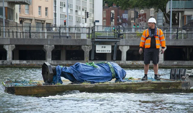 In this photograph made available by Bristol City Council, the statue of Edward Colston is recovered from the harbour in Bristol, Thursday June 11, 2020, after it was toppled by anti-racism protesters on Sunday. The council says it has been taken to a “secure location” and will end up in a museum. Colston built a fortune transporting enslaved Africans across the Atlantic, and left most of his money to charity. (Photo by Bristol City Council via AP Photo)