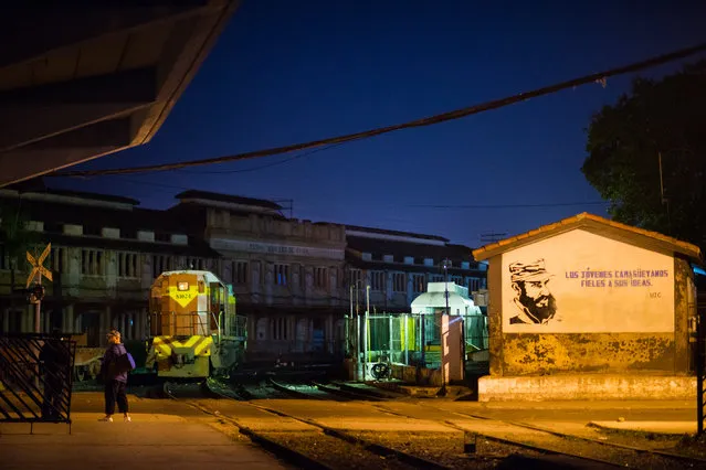 A sign painted on a building at a train stop in Camaguey features a picture of Fidel Castro and reads, The youth of Camaguey are faithful to their ideas. (Photo by Sarah L. Voisin/The Washington Post)