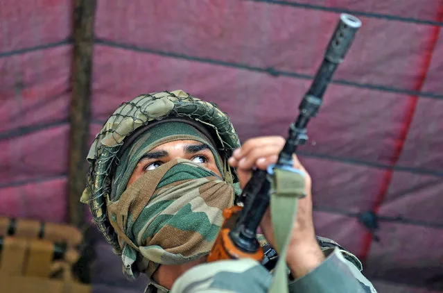 An Indian Border Security Force (BSF) soldier sits inside a truck upon arrival with others in Srinagar on August 23, 2016, to join thousands of federal forces and local policemen already deployed in the Kashmiri capital to contain a 46-day-old unrest. Official sources said that some 2,600 additional paramilitary troopers are being flown into Srinagar from Gujarat, Rajasthan and West Bengal to supplement the governments effort to contain the situation in the restive state of Jammu and Kashmir. (Photo by Tauseef Mustafa/AFP Photo)