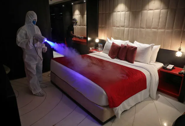 A worker wearing protective gear sanitizes a room at a hotel, after authorities eased lockdown restrictions that were imposed to slow the spread of the coronavirus disease (COVID-19), in Kolkata, India, June 15, 2020. (Photo by Rupak De Chowdhuri/Reuters)