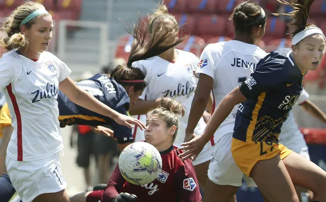 OL Reign goalie Michelle Betos and the Utah Royals Taylor Leach (24) fall to the ground after Leach’s attempt to score in a 2020 NWSL Challenge Cup game at Zions Bank Stadium in Herriman on Wednesday, July 8, 2020. (Photo by Laura Seitz/Deseret News)