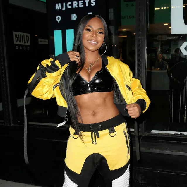 Singer Ashanti, wearing a bright yellow and black Michael Ngo track suit with black bra, exposes herself in the bitter cold outside Build Series in New York City, New York on November 30, 2017. (Photo by Christopher Peterson/Splash News and Pictures)