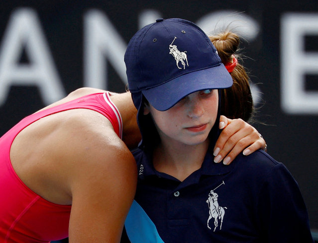 Ukraine's Marta Kostyuk hugs a ball kid after a point against Russia's Elina Avanesyan during their women's singles match on day six of the Australian Open tennis tournament in Melbourne on January 19, 2024. (Photo by Issei Kato/Reuters)